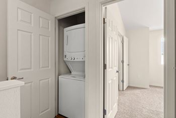 an empty laundry room with a washer and dryer in it at Trillium Apartments, Springfield, Oregon